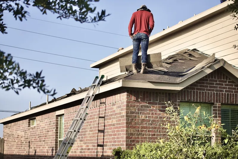 Professional roofer working on a residential roof in Stuttgart